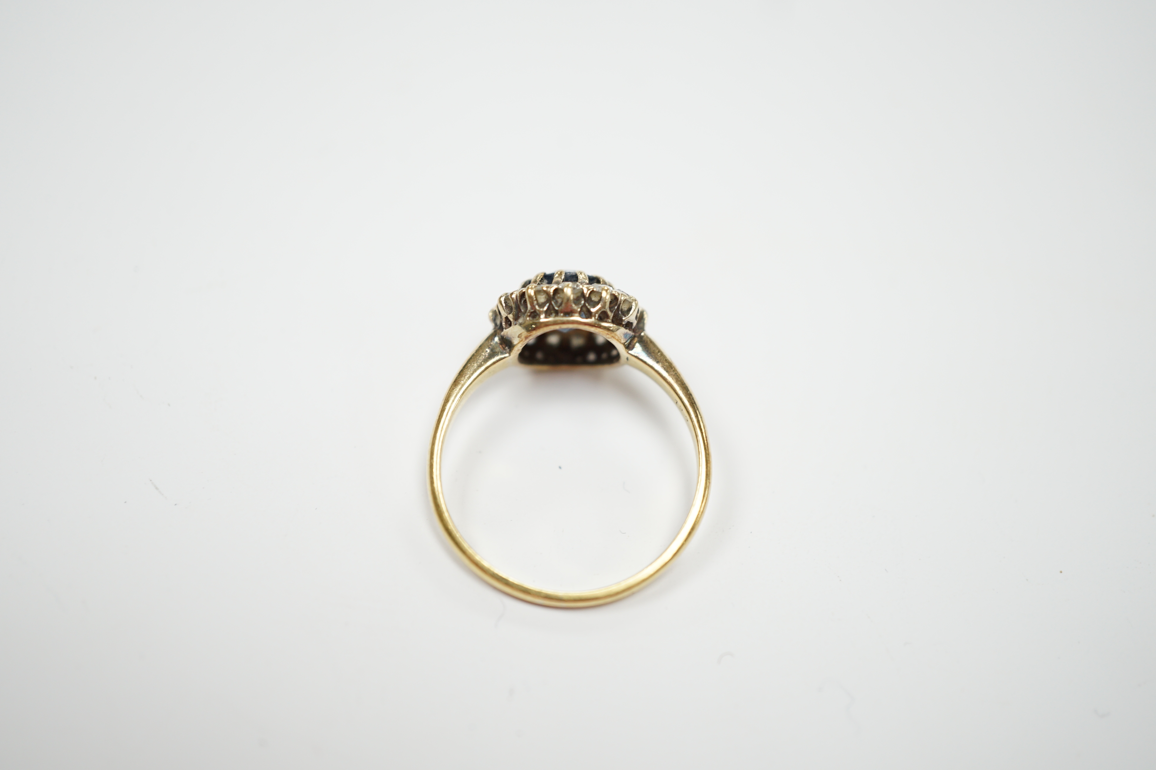 An early 20th century 18ct, sapphire and diamond set circular cluster ring, size P, gross weight 3.3 grams.